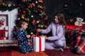 Mom with son at christmas tree with gifts new garland winter Royalty Free Stock Photo