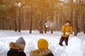 Mom, son and dad are playing snowball fight in winter forest. Family weekend. Royalty Free Stock Photo
