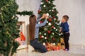 Mom with son decorate Christmas tree new year gifts Garland lights Royalty Free Stock Photo