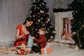 Mom with son decorate Christmas tree new year gifts Garland lights Royalty Free Stock Photo
