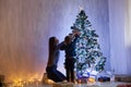 Mom with son decorate Christmas tree new year gifts Garland lights Royalty Free Stock Photo