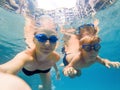 Mom and son in diving glasses swim in the pool under the water Royalty Free Stock Photo