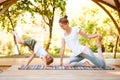 Mom and son do yoga in a summer park. Healthy lifestyle. Royalty Free Stock Photo