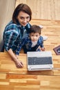 Mom and son are doing homework on the computer. Concept mom and children, modern technology and the Internet. Royalty Free Stock Photo