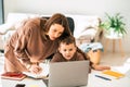 Mom and son doing school homework on laptop. Royalty Free Stock Photo