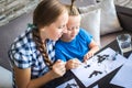 Mom with son draw a flying mouse Royalty Free Stock Photo