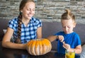 Mom with son draw a pumpkin for Halloween Royalty Free Stock Photo