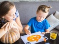 Mom with son draw a pumpkin for Halloween Royalty Free Stock Photo