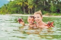 Mom and son found a red starfish in the sea Royalty Free Stock Photo