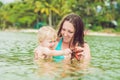 Mom and son found a red starfish in the sea Royalty Free Stock Photo