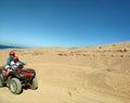 Mom with a son going through the desert on a squad bike, Sinai mountains, hills Royalty Free Stock Photo