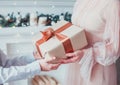 Mom and son are holding a gift box. Warm colors. Christmas concept