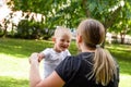 Mom and son holds hands in nature, park, outdoor. Laughing smiling child. Trust and love in family. Summer family walk