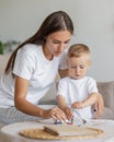 mom and son at home in the living room hugging and playing. parenthood of a young single mom and her son. a small child Royalty Free Stock Photo