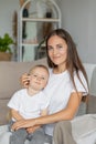 mom and son at home in the living room hugging and playing. parenthood of a young single mom and her son. a small child Royalty Free Stock Photo