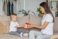 mom and son at home in the living room hugging and playing. parenthood of a young single mom and her son. a small child Royalty Free Stock Photo