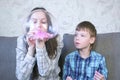 Mom and son inflate a big bubbles from a slimes. Play with slime. Royalty Free Stock Photo