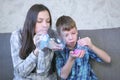 Mom and son inflate a big bubbles from a slimes. Play with slime. Royalty Free Stock Photo