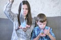 Mom and son inflate a big bubbles from a slimes. Play with slime. Royalty Free Stock Photo