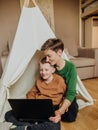 Mom son laptop browsing internet leisure entertainment Royalty Free Stock Photo