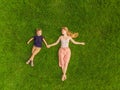 Mom and son are lying on the grass in the park, photos from the drone, quadracopter Royalty Free Stock Photo