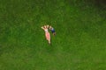 Mom and son are lying on the grass in the park, photos from the drone, quadracopter Royalty Free Stock Photo