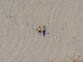 Mom and son are lying on the sand at sunset. View from the drone. Paradise, travel, vacation concept Royalty Free Stock Photo