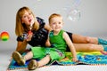 Mom and son playing with soap bubbles Royalty Free Stock Photo