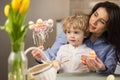 Mom and son prepare Easter decorations. Royalty Free Stock Photo