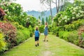 Mom and son are running around in the blooming garden. Happy family life style concept