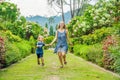 Mom and son are running around in the blooming garden. Happy family life style concept