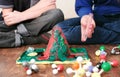 Mom and son`s hands make experience with plasticine volcano at home. Chemical reaction with gas emission.