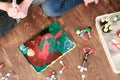 Mom and son`s hands make experience with plasticine volcano at home. Chemical reaction with gas emission. Top view.