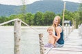 Mom and son are sitting on the old pier and enjoying the sea Royalty Free Stock Photo