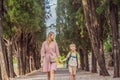 Mom and son tourists walking together in Montenegro. Panoramic summer landscape of the beautiful green Royal park Royalty Free Stock Photo