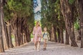 Mom and son tourists walking together in Montenegro. Panoramic summer landscape of the beautiful green Royal park Royalty Free Stock Photo