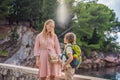 Mom and son tourists walking together in Montenegro. Panoramic summer landscape of the beautiful green Royal park Royalty Free Stock Photo