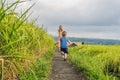 Mom and son travelers on Beautiful Jatiluwih Rice Terraces against the background of famous volcanoes in Bali, Indonesia Royalty Free Stock Photo