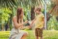 Mom and son use mosquito spray.Spraying insect repellent on skin outdoor Royalty Free Stock Photo