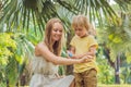 Mom and son use mosquito spray.Spraying insect repellent on skin outdoor Royalty Free Stock Photo
