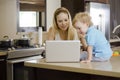 Mom and son using a laptop