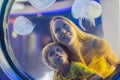 Mom and son watching the jellyfish on blue background in Aquarium Royalty Free Stock Photo
