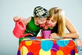 Mom and son watering flowers with a watering can