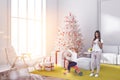 Mom and son in white living room, fir tree, gifts