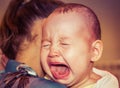 Mom soothes baby. The baby is crying Royalty Free Stock Photo