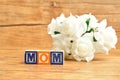 Mom spelled with alphabet blocks and a bunch of white roses Royalty Free Stock Photo