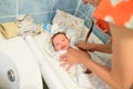 Mom swaddles the baby. on the table of pelina in the bath. Mom and her baby. The concept of a happy family. Beautiful conceptual