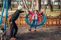 Mom swing her daughter on a swing in the autumn park Royalty Free Stock Photo