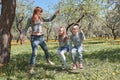 Mom swings her kids on the garden swing Royalty Free Stock Photo