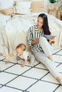 .mom with tablet and baby toddler